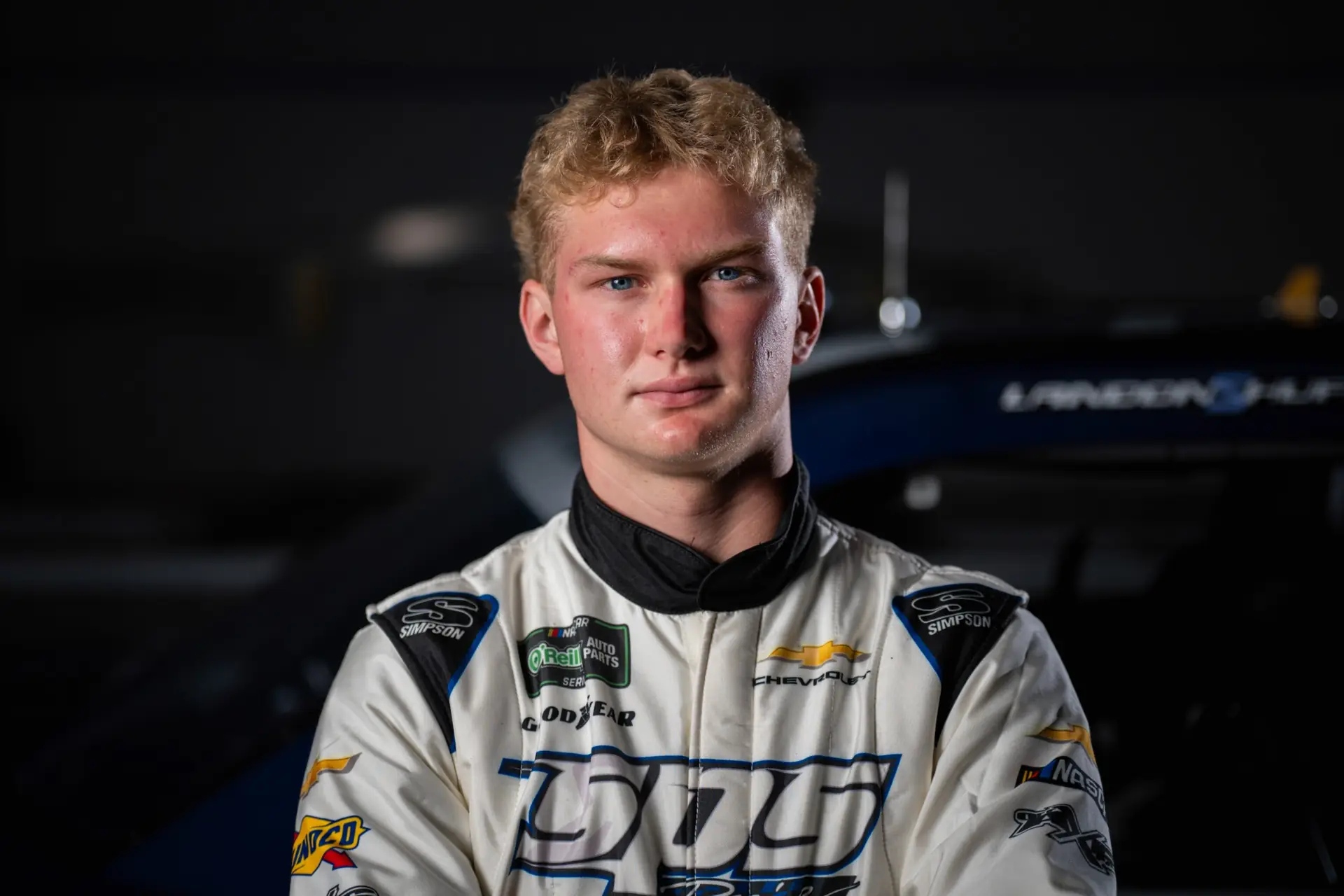 Portrait of Landon S. Huffman wearing a white racing suit.