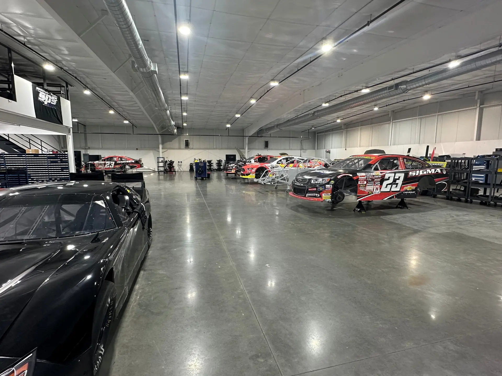 Race cars parked inside the SPS hauler bay.